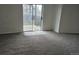Open living area featuring plush carpet and access to outdoor patio space at 18531 E Tanforan Pl, Aurora, CO 80015