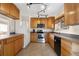 Bright kitchen with wooden cabinets, stainless steel appliances, and tile flooring at 11624 Claude Ct, Northglenn, CO 80233