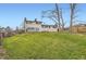 Back of house with a large, grassy yard and mature trees at 789 Hamal Dr, Lone Tree, CO 80124