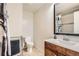 Bright bathroom featuring a toilet, vanity with sink, and decorative mirror at 789 Hamal Dr, Lone Tree, CO 80124
