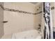 Jetted bathtub with tile surround and decorative pebble accents at 789 Hamal Dr, Lone Tree, CO 80124