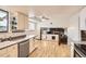 Bright kitchen with white cabinets, countertops, stainless steel appliances, and hardwood floors at 789 Hamal Dr, Lone Tree, CO 80124