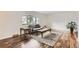 Bright living room featuring hardwood floors, a large window, a gray sofa, and a decorative rug at 789 Hamal Dr, Lone Tree, CO 80124