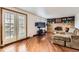 Bright living room boasts hardwood floors, brick fireplace, and access to the backyard at 789 Hamal Dr, Lone Tree, CO 80124