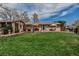 Spacious backyard with a well-maintained lawn, patio, and lush greenery at 3630 W Saratoga Ave, Littleton, CO 80123