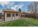 This backyard features a storage shed, chicken coop, and grass lawn at 3630 W Saratoga Ave, Littleton, CO 80123