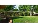 Spacious, green backyard enclosed by a lush, overgrown fence provides a private outdoor space at 3630 W Saratoga Ave, Littleton, CO 80123