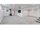 Spacious finished basement with a rustic wood stove, tv and a door at 3630 W Saratoga Ave, Littleton, CO 80123