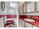 Bathroom featuring skylight, sink, and red tile backsplash at 3630 W Saratoga Ave, Littleton, CO 80123