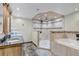 Luxurious bathroom with double sinks, granite countertops, and a tiled walk-in shower and tub at 3630 W Saratoga Ave, Littleton, CO 80123