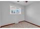 Bright bedroom with neutral tones, carpet flooring, and natural light from a window at 3630 W Saratoga Ave, Littleton, CO 80123