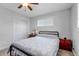 Cozy bedroom features a comfortable bed, ceiling fan and a storage chest near the window at 3630 W Saratoga Ave, Littleton, CO 80123