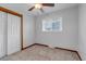 Bright bedroom with neutral carpet, trim and a closet with double sliding doors at 3630 W Saratoga Ave, Littleton, CO 80123