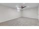 A minimalistic bedroom with neutral carpet, ceiling fan, and a single window at 3630 W Saratoga Ave, Littleton, CO 80123