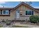 Home exterior showcasing the front door, stone accents, decorative landscaping, and updated paint at 3630 W Saratoga Ave, Littleton, CO 80123