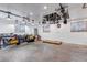 Spacious garage with well-lit interior, featuring ample storage, workspace, and bike hanging system at 3630 W Saratoga Ave, Littleton, CO 80123