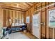 Interior view of shed with exposed beams, natural light, workbench, and ample storage space at 3630 W Saratoga Ave, Littleton, CO 80123