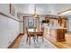 Eat-in kitchen features a dining table, glass door, and custom wood cabinetry at 3630 W Saratoga Ave, Littleton, CO 80123
