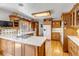 Traditional kitchen features custom wood cabinets, white countertops, and hardwood floors at 3630 W Saratoga Ave, Littleton, CO 80123