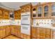 Kitchen featuring custom wood cabinets, built-in double ovens, and ample counter space for cooking and entertaining at 3630 W Saratoga Ave, Littleton, CO 80123