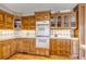 Well-lit kitchen featuring custom wood cabinets, double oven, and updated countertops at 3630 W Saratoga Ave, Littleton, CO 80123