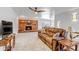 Spacious living room featuring a brick fireplace, plush sofa, and neutral color palette at 3630 W Saratoga Ave, Littleton, CO 80123