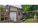 Exterior of an outbuilding with a garage door, surrounded by greenery and a wooden fence at 3630 W Saratoga Ave, Littleton, CO 80123