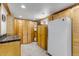 A walk-in pantry with custom wood cabinets, shelving, and a full-size refrigerator at 3630 W Saratoga Ave, Littleton, CO 80123