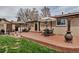 Brick patio with outdoor seating, tables, and umbrellas, creating an inviting space for relaxation and socializing at 3630 W Saratoga Ave, Littleton, CO 80123