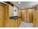 Organized storage room with light-colored wood cabinets, granite countertop, and neutral carpet at 3630 W Saratoga Ave, Littleton, CO 80123