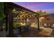 Backyard featuring a covered outdoor dining area with string lights, perfect for evening gatherings and entertainment at 12256 W 34Th Pl, Wheat Ridge, CO 80033
