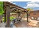 Inviting backyard patio with a wooden pergola, outdoor dining set, and comfortable seating, perfect for entertaining at 12256 W 34Th Pl, Wheat Ridge, CO 80033