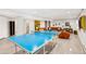 Finished basement with ping pong table, neutral walls, and plush seating area at 12256 W 34Th Pl, Wheat Ridge, CO 80033