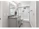 Modern bathroom with white subway tile, glass-enclosed shower, granite countertop and neutral gray color palette at 12256 W 34Th Pl, Wheat Ridge, CO 80033
