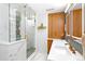 Elegant bathroom featuring a marble shower, custom vanity, and modern fixtures at 12256 W 34Th Pl, Wheat Ridge, CO 80033