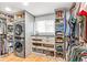 Spacious walk-in closet featuring built-in shelving, organizers, and a laundry area at 12256 W 34Th Pl, Wheat Ridge, CO 80033