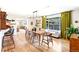 Bright dining room featuring wood floors, modern lighting, and a view to the outdoor patio at 12256 W 34Th Pl, Wheat Ridge, CO 80033