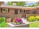 Charming brick home featuring a cozy front patio with a wooden fence at 12256 W 34Th Pl, Wheat Ridge, CO 80033