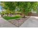 Inviting home with verdant lawn, mature trees, and manicured front yard landscaping creates an appealing curb appeal at 12256 W 34Th Pl, Wheat Ridge, CO 80033
