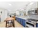 Bright modern kitchen features stainless appliances, white cabinets, and functional center island at 12256 W 34Th Pl, Wheat Ridge, CO 80033