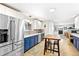 Modern kitchen features stainless steel appliances, light countertops, and a central island at 12256 W 34Th Pl, Wheat Ridge, CO 80033