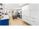 Bright modern kitchen features stainless appliances, white cabinets, and functional island at 12256 W 34Th Pl, Wheat Ridge, CO 80033