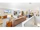Open-concept layout with a leather sofa, a view of kitchen, and outdoor access at 12256 W 34Th Pl, Wheat Ridge, CO 80033