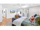 Spacious main bedroom with wood floors, TV, and sitting area with a cozy chair at 12256 W 34Th Pl, Wheat Ridge, CO 80033