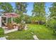 Landscaped backyard featuring a patio, green lawn, and garden archway at 6940 W 63Rd Ave, Arvada, CO 80003