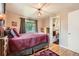 Comfortable bedroom features hardwood floors, large window, and an ensuite bathroom for added convenience at 6940 W 63Rd Ave, Arvada, CO 80003