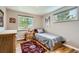 Bright bedroom featuring hardwood floors, a window with blinds, and a twin size bed with wood frame at 6940 W 63Rd Ave, Arvada, CO 80003