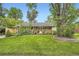Inviting ranch-style home with mature trees, lush lawn, and a welcoming front entrance at 6940 W 63Rd Ave, Arvada, CO 80003