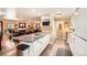 Bright, updated kitchen with an island, white cabinetry, and a view into the living area at 6940 W 63Rd Ave, Arvada, CO 80003