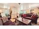 Open-concept living area with hardwood floors, comfortable sofas, and a bright atmosphere at 6940 W 63Rd Ave, Arvada, CO 80003